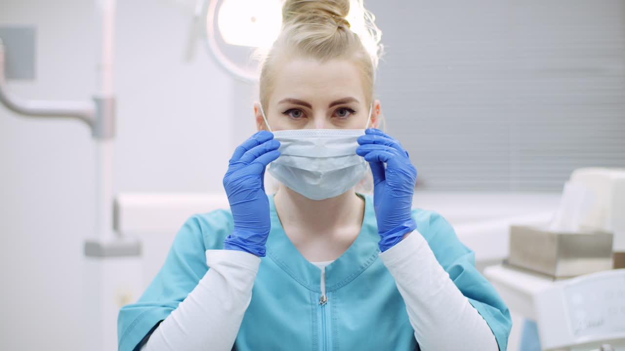 Dentist Putting On Protective Mask Before Surgery 3
