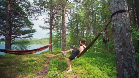 man with hammock relaxing on the woods