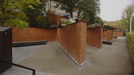 modern brick and mirror sculpture in urban garden