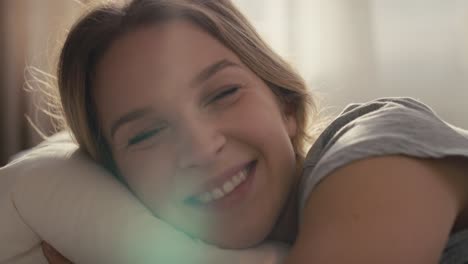 Caucasian-woman-lying-in-bed-at-morning-and-looking-at-camera