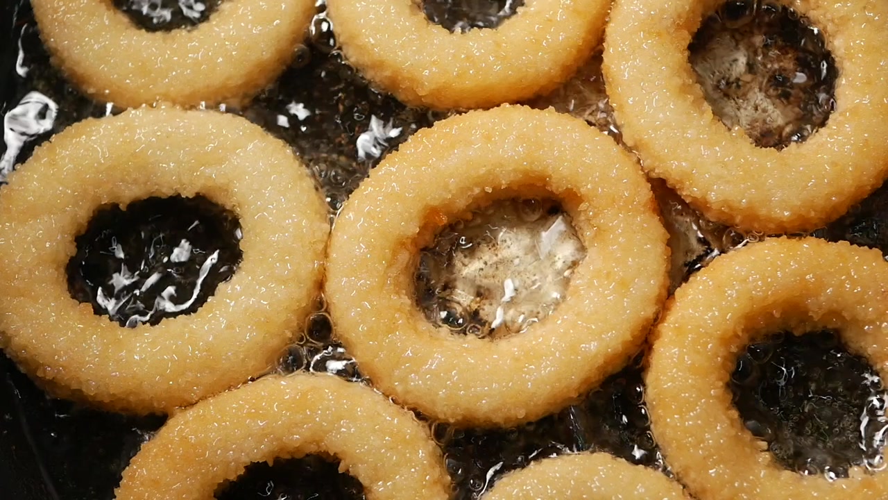 Golden Onion Rings Frying in Hot Oil in a Pan
