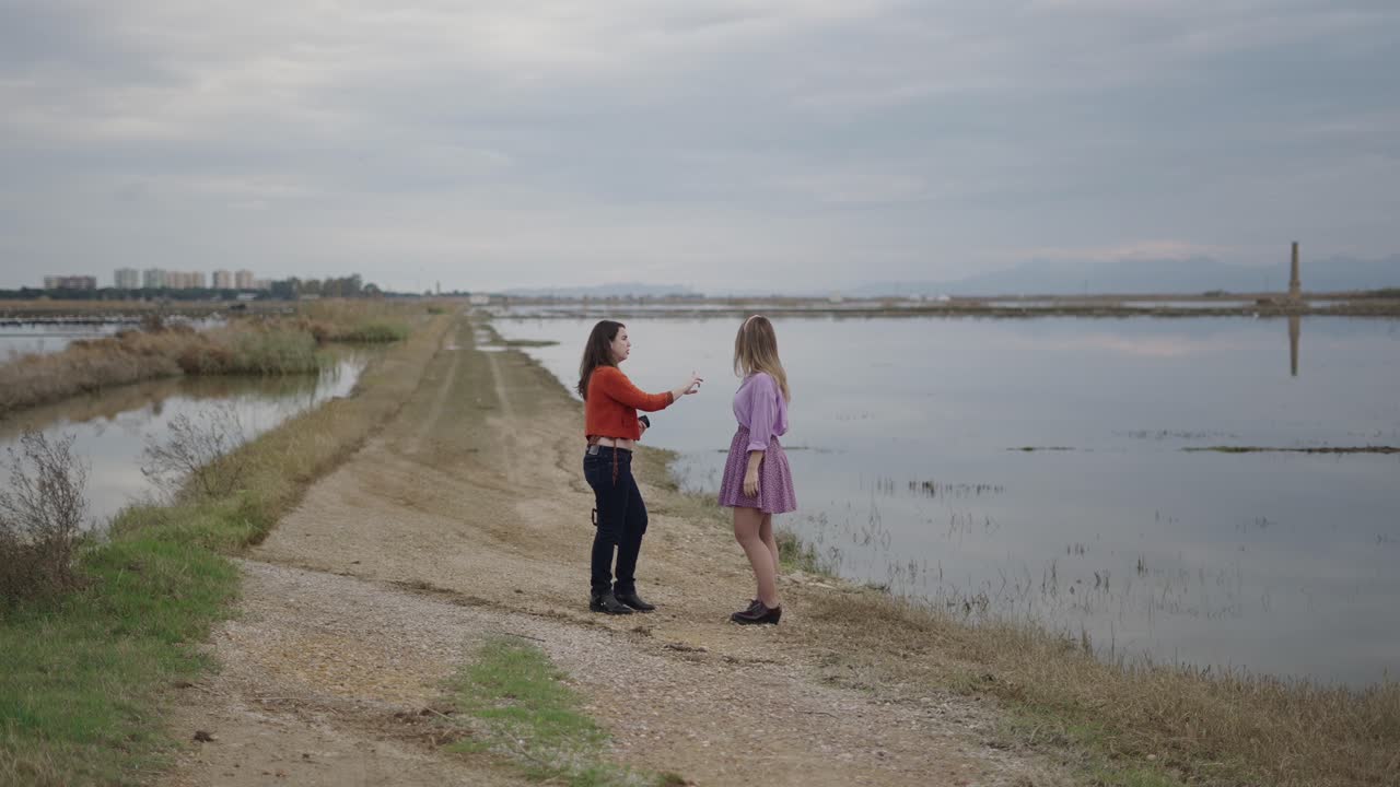 Two Women on a Path by the Water