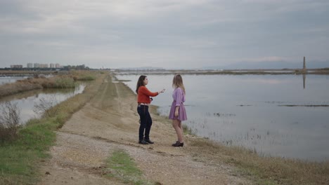 two women on a path by the water