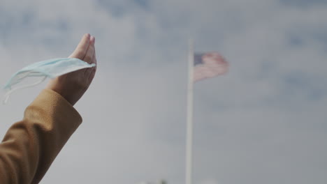 woman with a protective mask in her hand, end of quarantine concept.