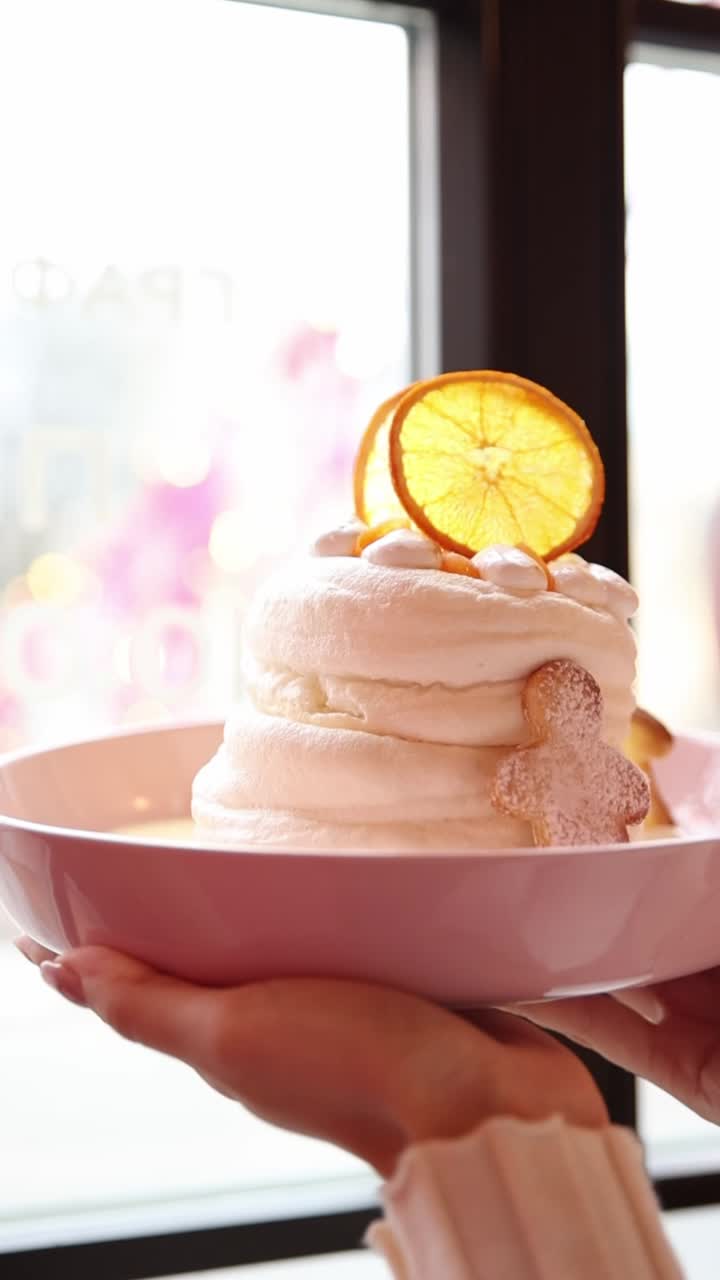 Delicious layered dessert with whipped cream, orange slices, and gingerbread cookies