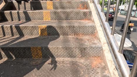 individual walking down a metal staircase