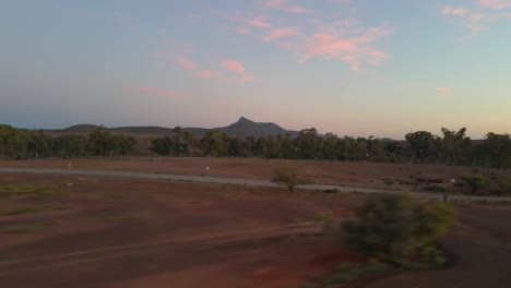 Aerial-tracking-shot-flock-of-bird-flying-on-Australian-Outback-landscape