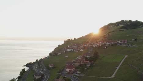 Flying-over-small-rural-mountain-town-at-sunset