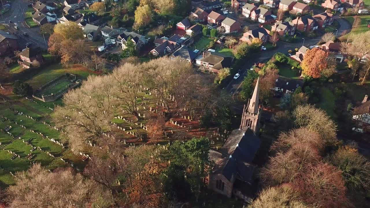 Aerial rotating shot above UK church in rural town