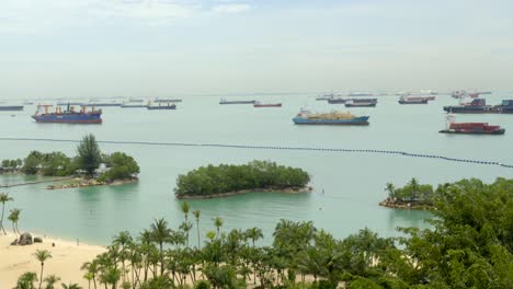 aerial panning shot of singapore sentosa island cableway bay pier sea