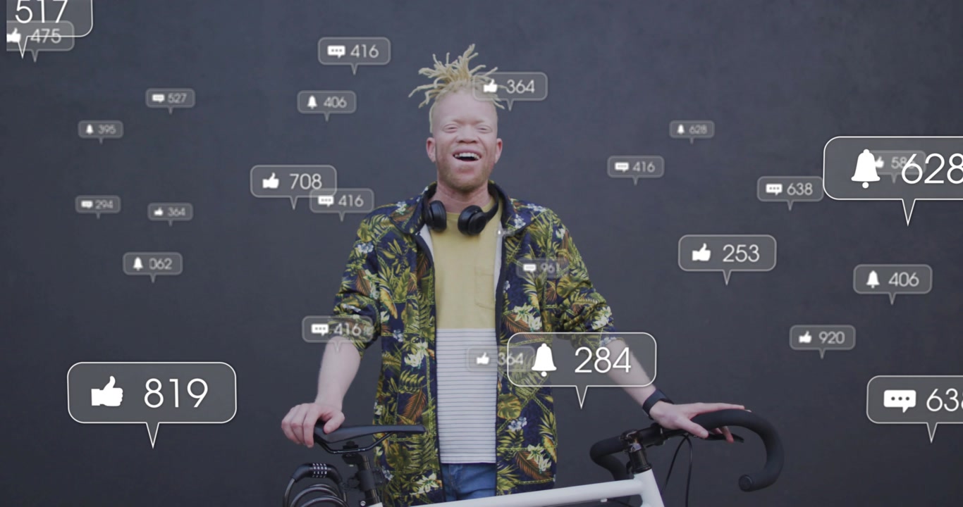 Man presenting bicycle in studio, receiving floating alerts and celebrating social media engagement