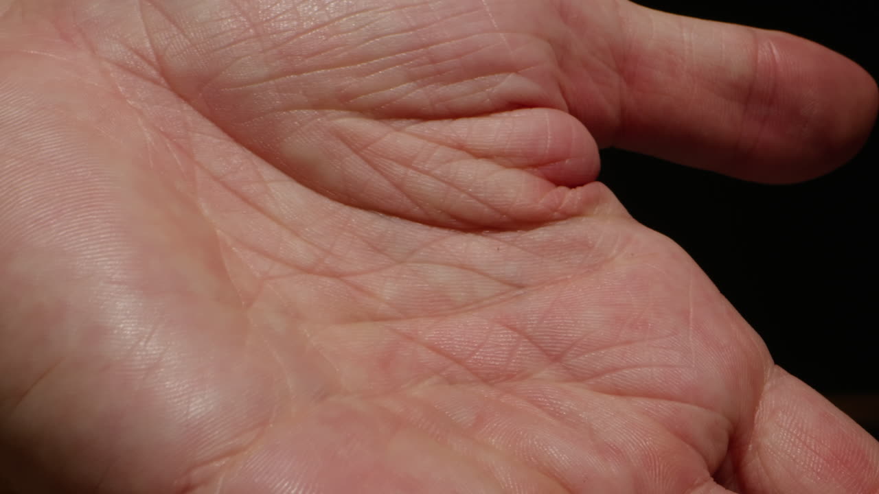 Close-up of man hand skin texture. Macro Detailed human skin, lines on hand palm. Life line, reading, foretelling the future through the study of the palm