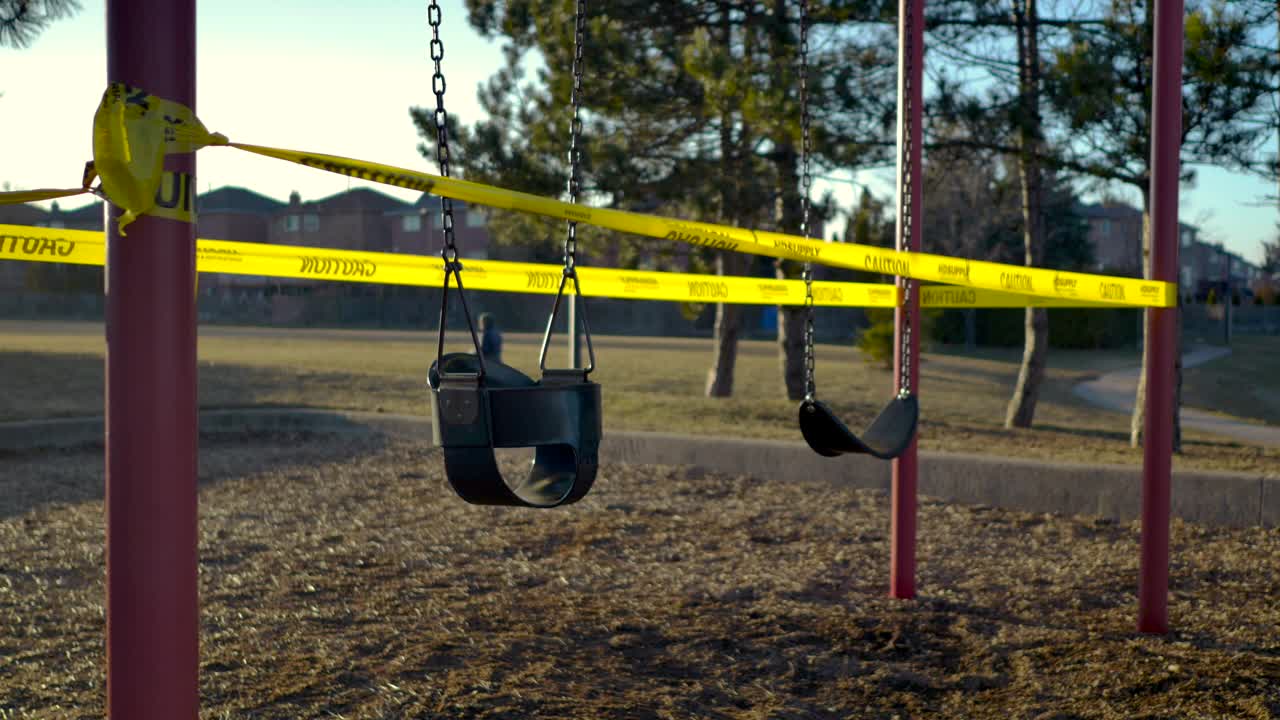 Playground Closure Swings Caution Tape Static Magic Hour Dog Walker In Background