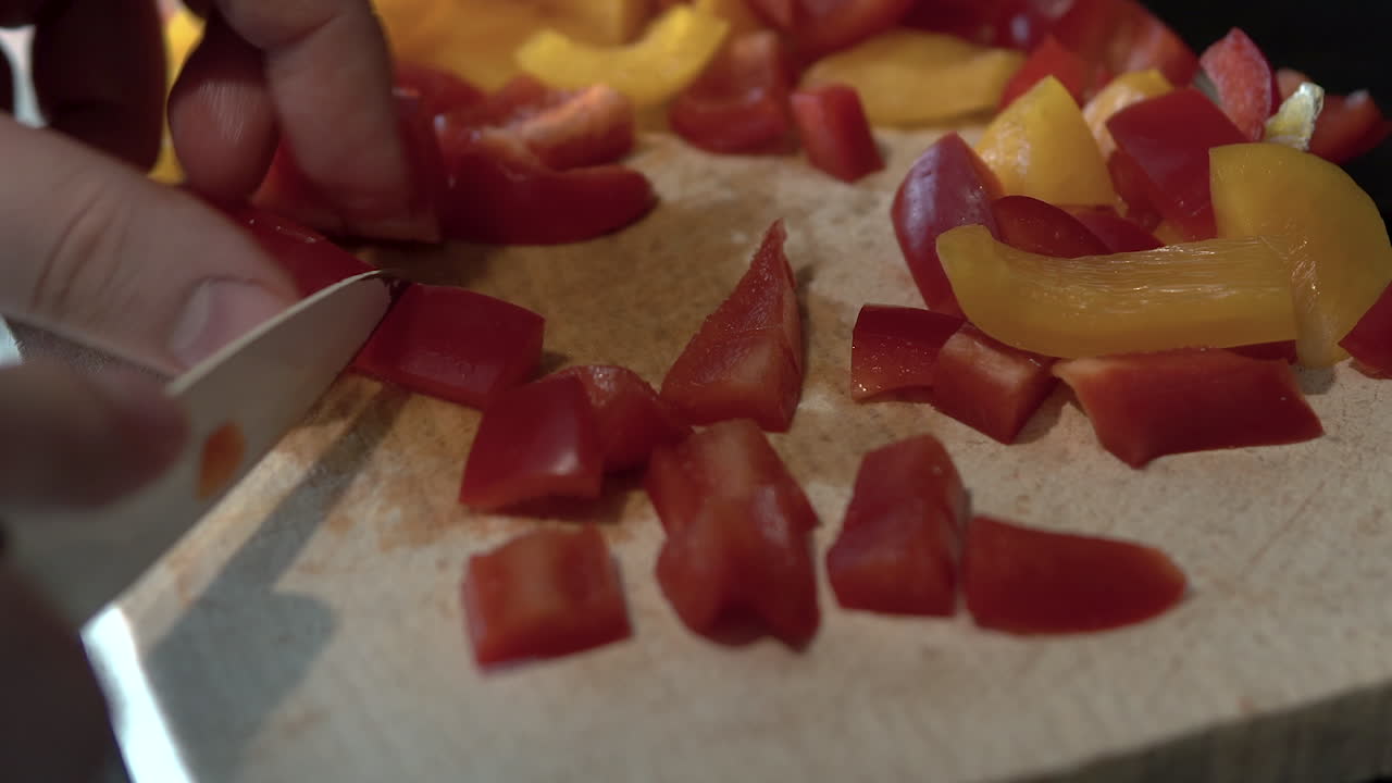 Preparing diced red and yellow bell peppers