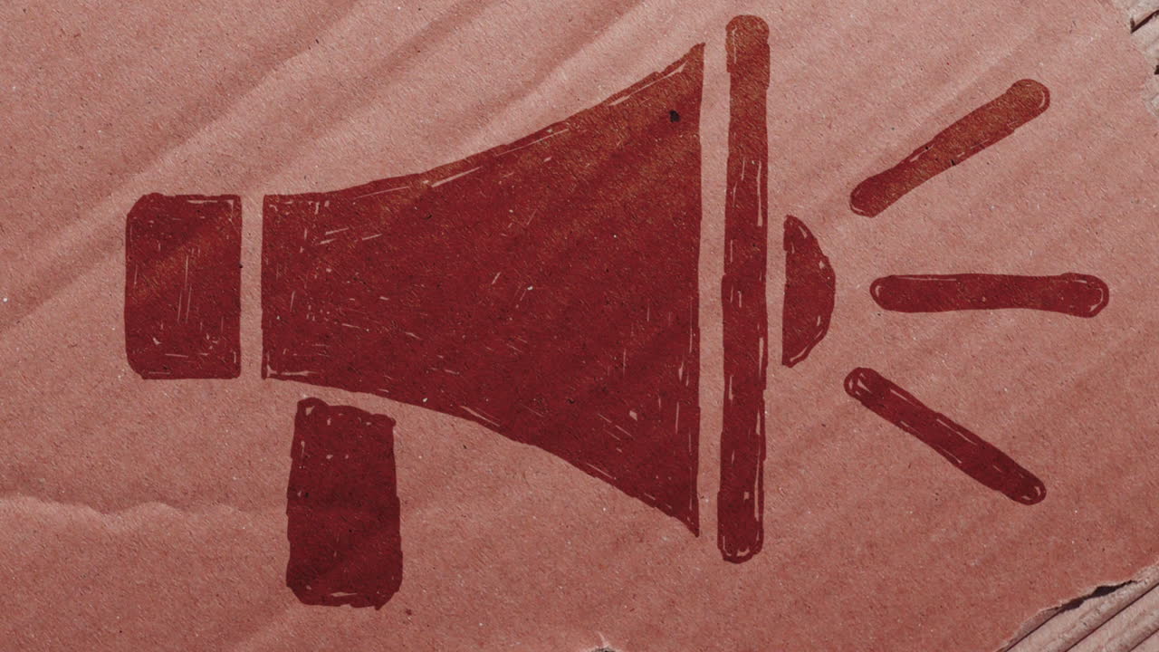 Animazione stop motion con simbolo megafono rosso su cartone che si strappa