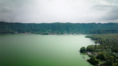 high angle aerial over contaminated lake batur with tilapia fish farming, bali