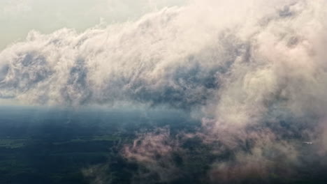 fluffy clouds and latvian landscape, high altitude aerial view