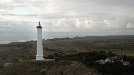 aerial footage of a lighthouse near the shore on the western coast of jutland, denmark