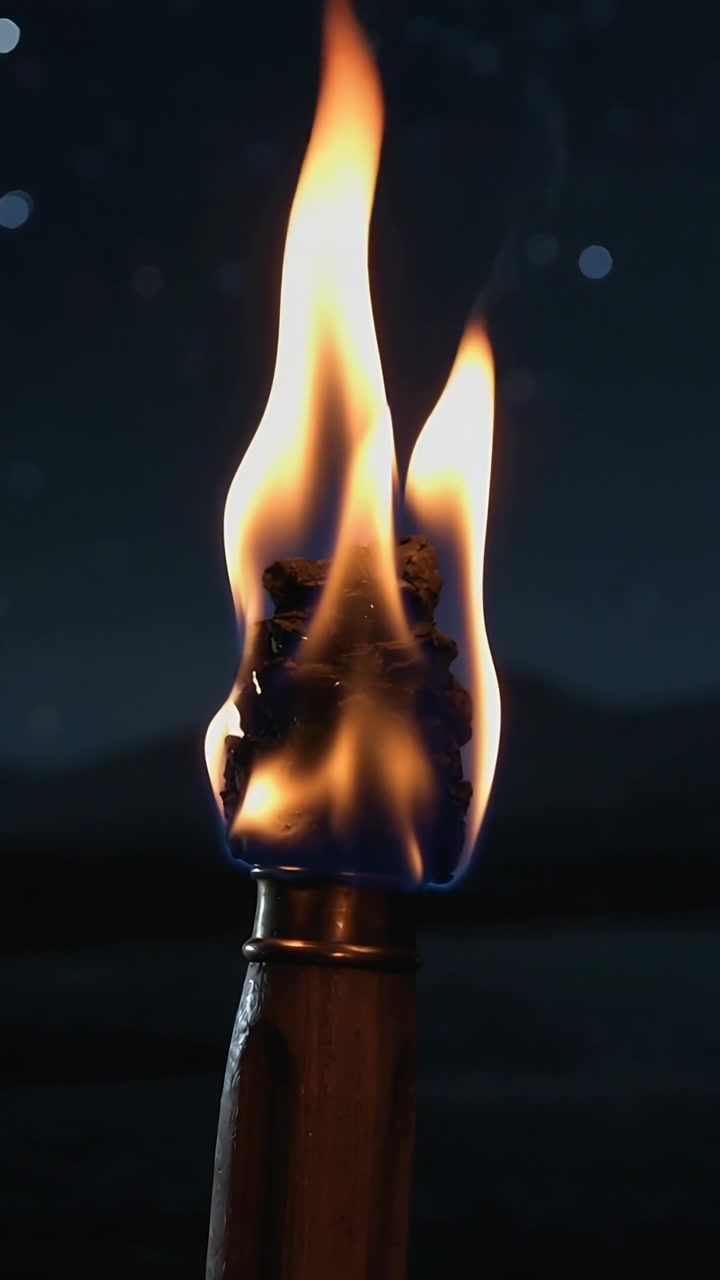 Vertical video: Flickering handheld torch exposing charred wick, flame growing by breeze at lake