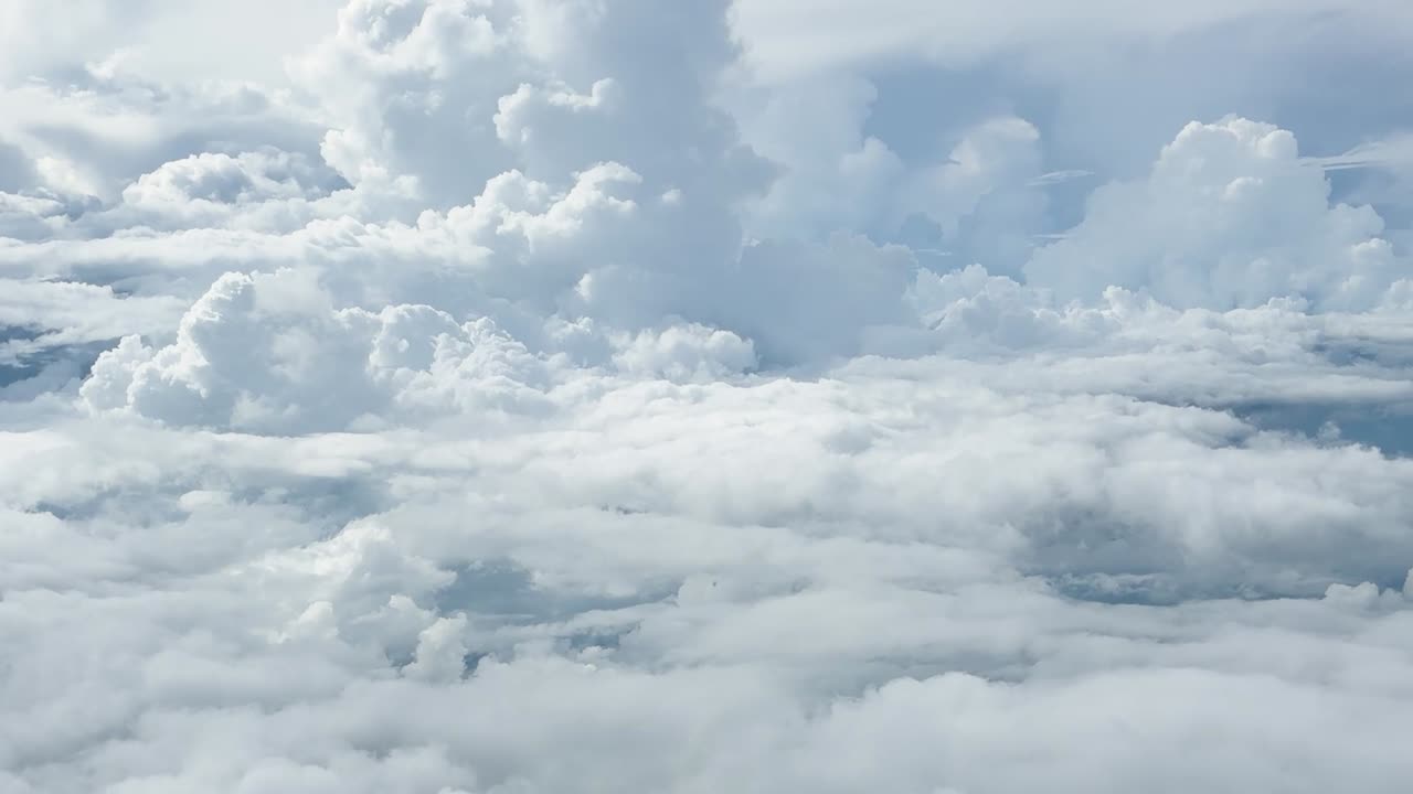 Cinematic flight through dense white cloud formations under a bright and clear blue sky