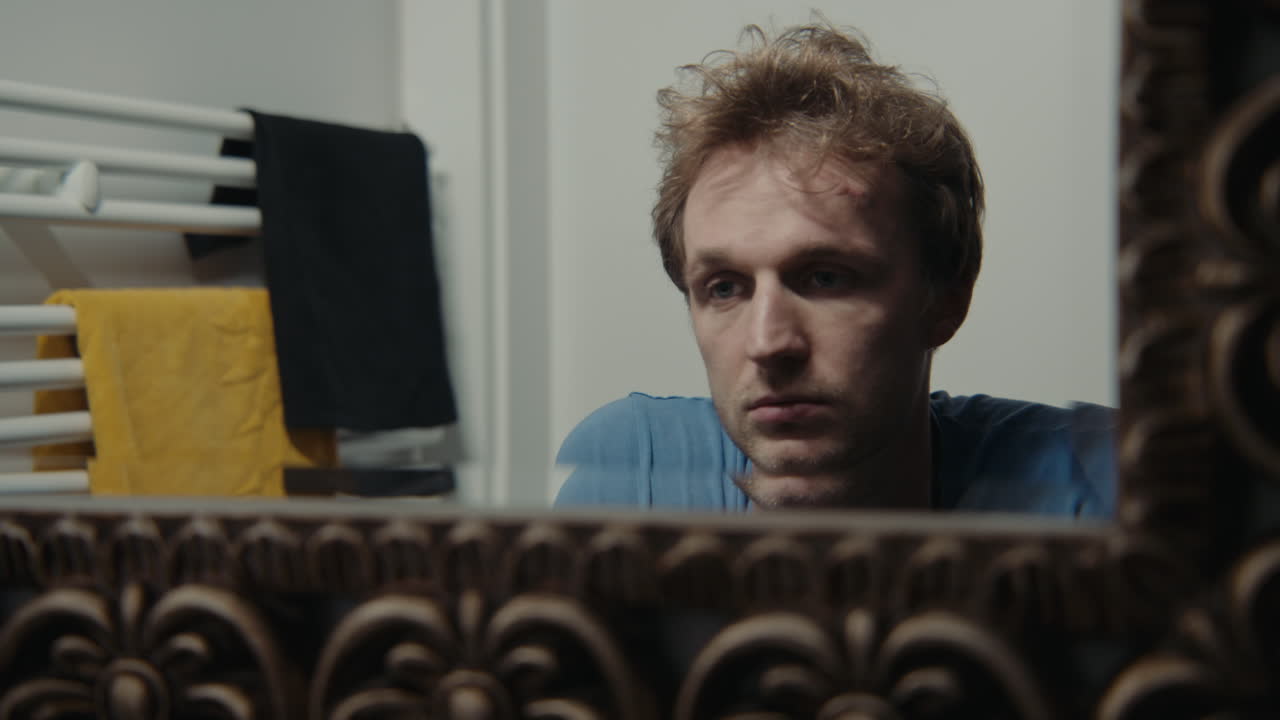 Man looking in the bathroom mirror