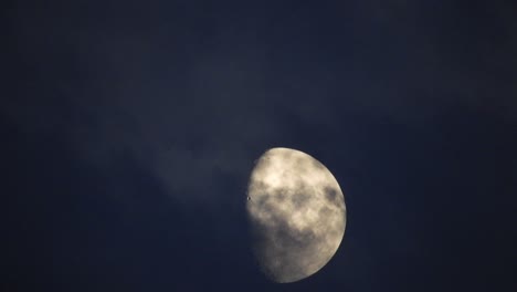 moon at night with cloud real time. 4k video moon in the black sky.  clouds passing by moon at night. night sky with cloudy weather