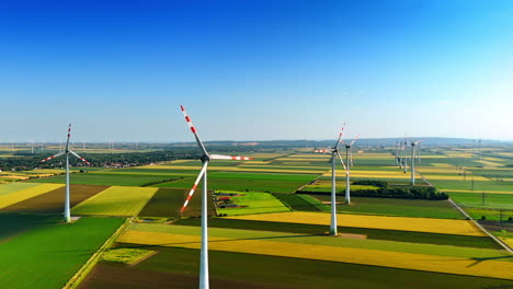 beautiful green fields with multiple wind mills. clean energy concept. aerial view.