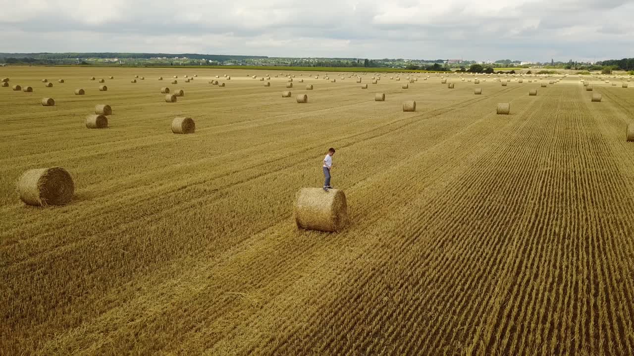 Child Boy In The Field. Child boy in the field against straw bales