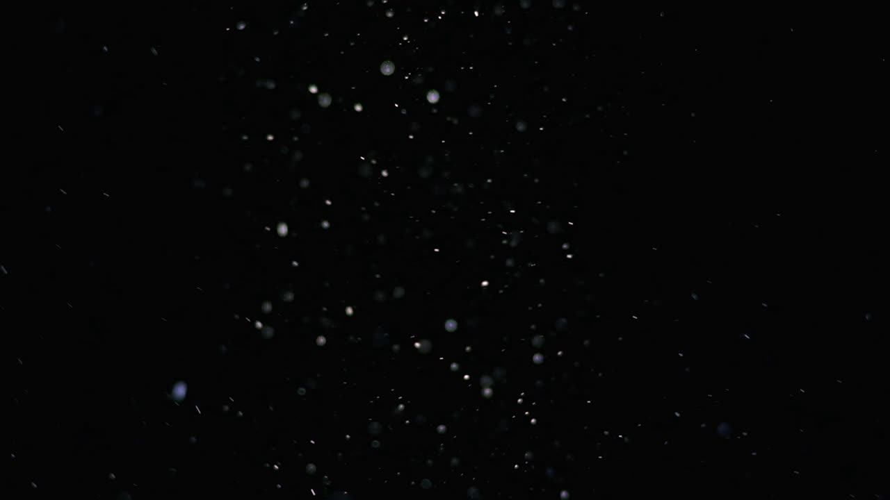 The magic falling of white particles. slow motion
