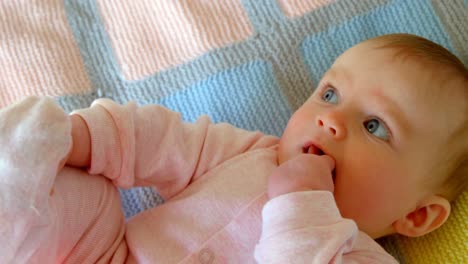 Front-view-of-cute-caucasian-baby-relaxing-on-baby-bed-in-a-comfortable-home-4k