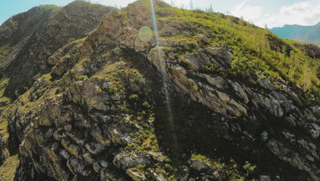 rocky peaks stand bathed under sunrays. silent witness to untamed force of natural world with light playing gracefully over rugged surface