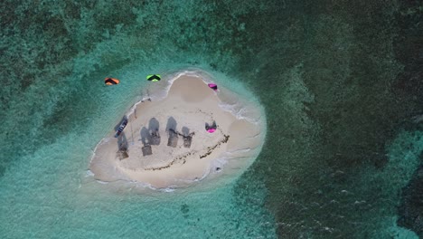 tropical paradise island, kiteboarders, top down aerial shot, slow motion