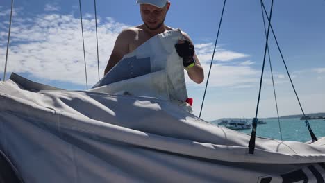 sailor working on a sailboat