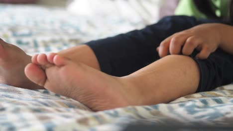 child's feet on bed