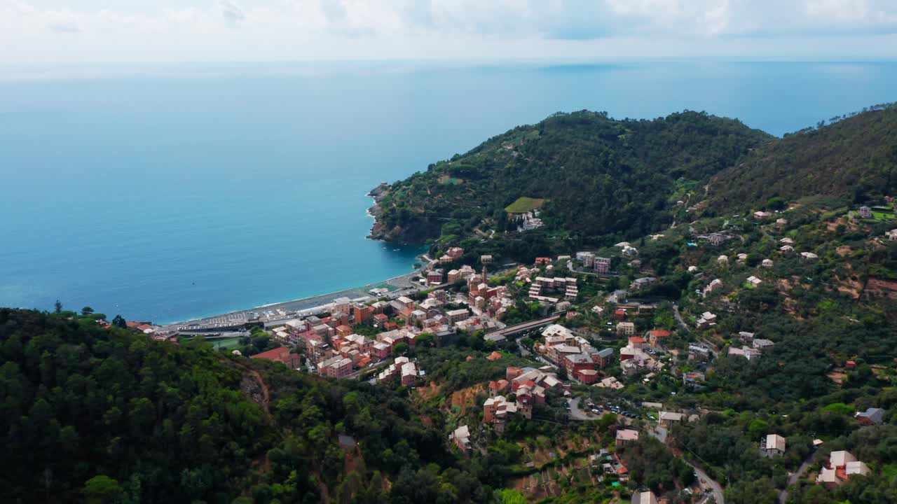 Small Mediterranean harbor town on the edge of a mountain range,drone aerial