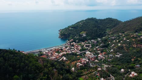 small mediterranean harbor town on the edge of a mountain range,drone aerial