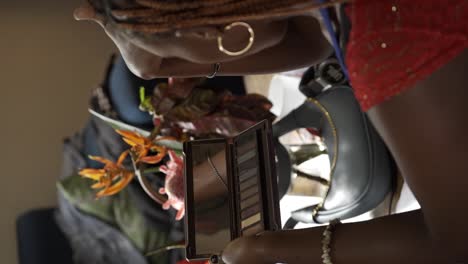 Ugandan-Woman-Applying-her-Makeup---Vertical-Shot