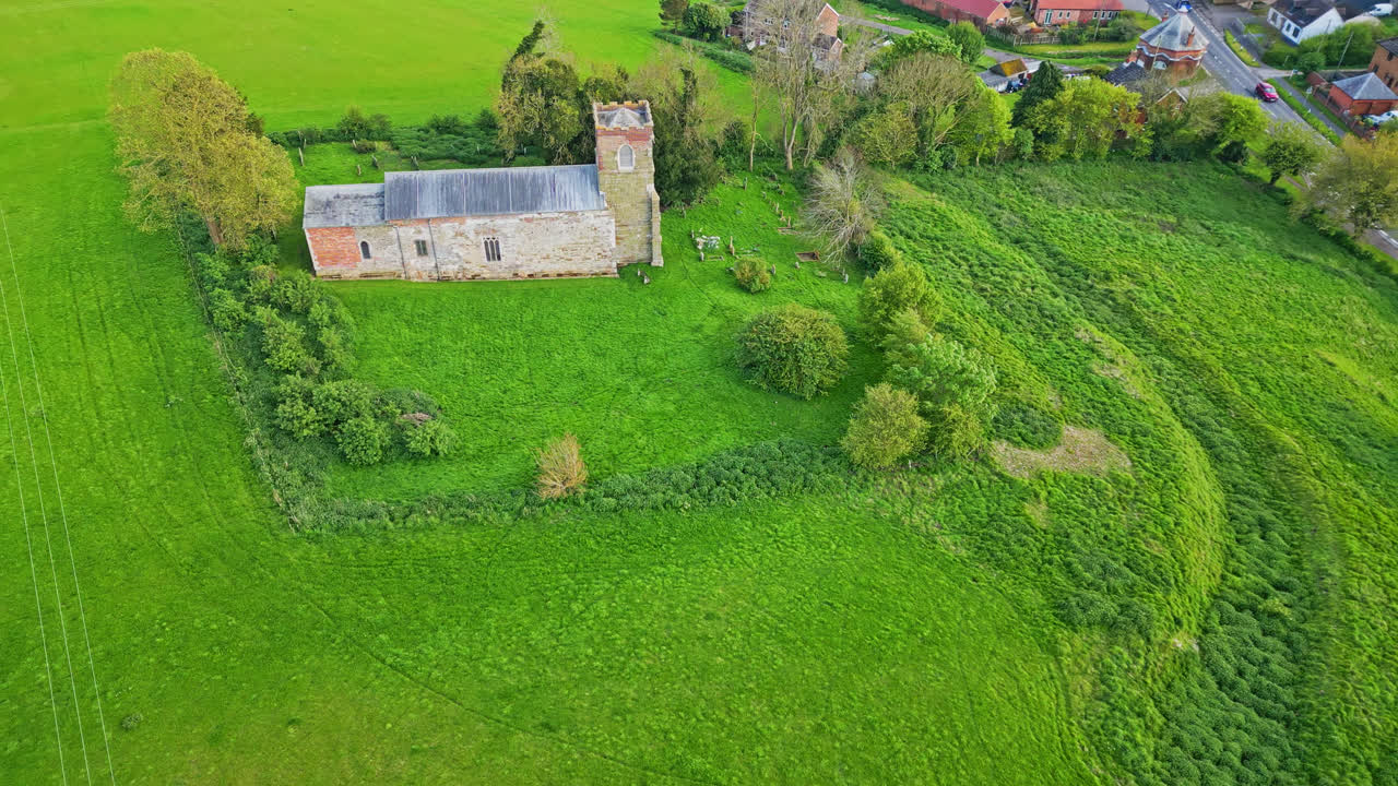 Captured by drone: Burwell village, once a medieval market town, with rural fields, ancient red brick homes, and the idle Saint Michael parish church on the Wold Hills of Lincolnshire