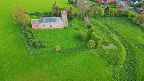 Captured-by-drone:-Burwell-village,-once-a-medieval-market-town,-with-rural-fields,-ancient-red-brick-homes,-and-the-idle-Saint-Michael-parish-church-on-the-Wold-Hills-of-Lincolnshire