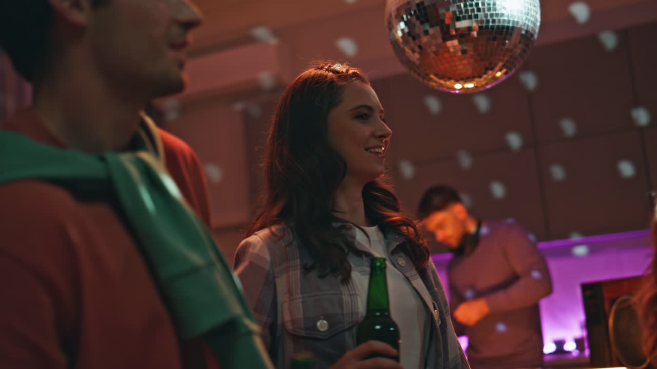 Cheerful youngsters dancing home gathering late evening closeup. People party