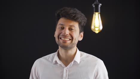 el joven inteligente encuentra nuevos inventos, ideas y la lámpara se enciende.
