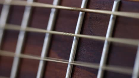 close-up of guitar strings and fretboard
