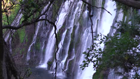 a side view of burney falls cascading down volcanic rocks at burney falls state park in shasta county