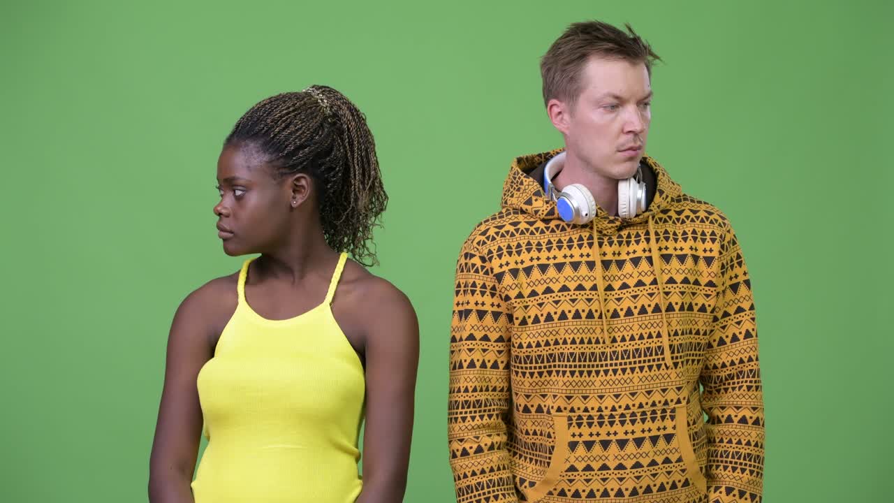 Young multi-ethnic couple looking away together