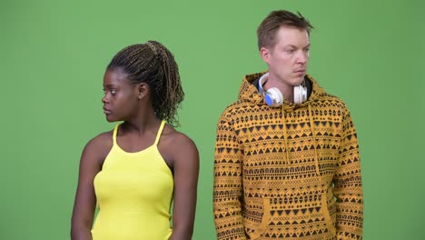 young multi-ethnic couple looking away together