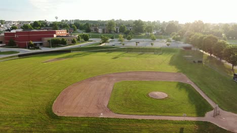 aerial truck shot of baseball field of dreams during morning sunrise at public school grounds in united states