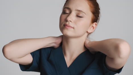 redheaded doctor in front of camera on gray background.