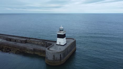 Holyhead-Rompeolas-Faro-Más-Largo-Concreto-Costero-Mar-Protección-Hito-Aéreo-Lento-Izquierda-Rotación-Vista