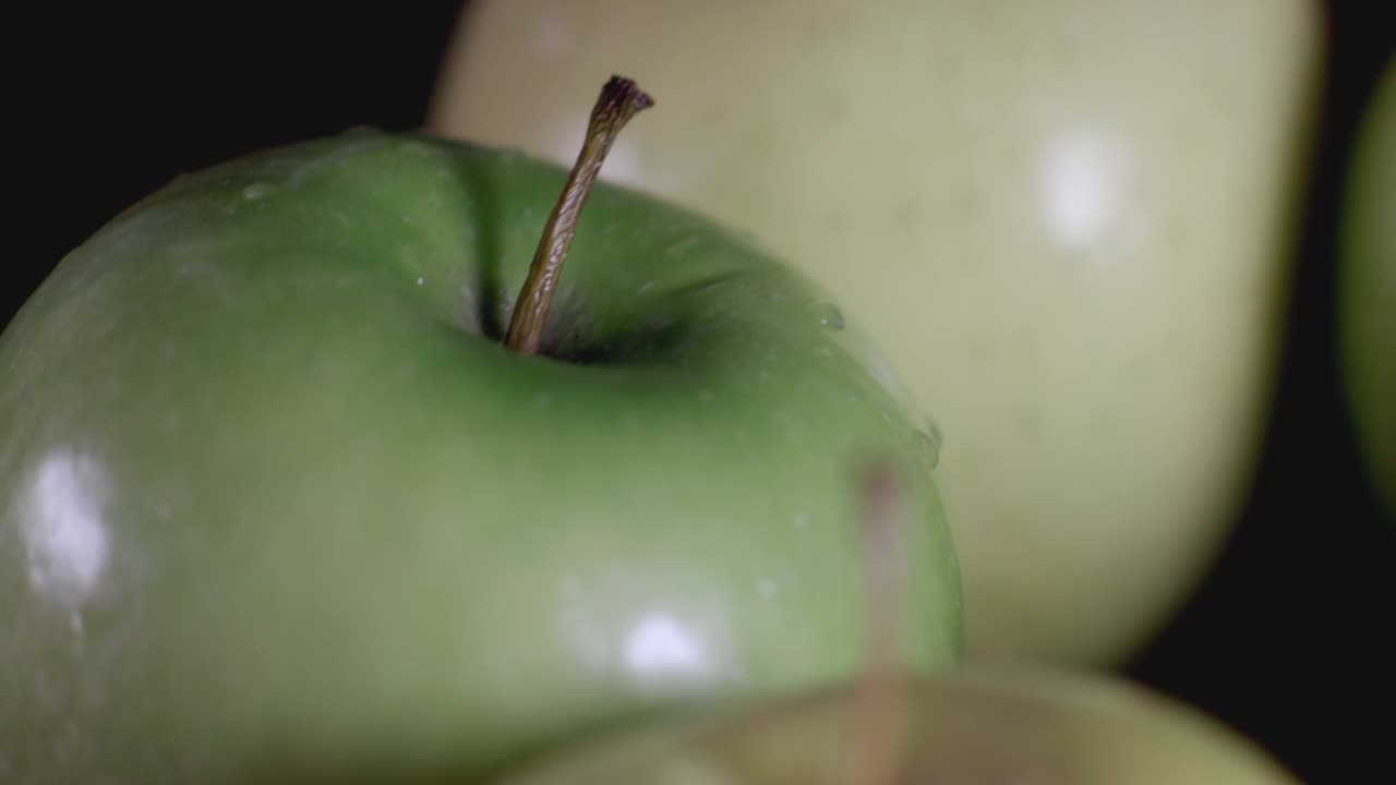 Yellow And Green Fresh Apples Spinning On Table Top - Closeup Shot