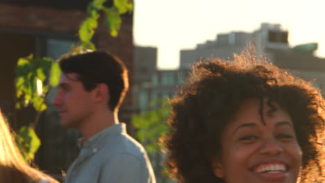 Young-adult-friends-dancing-at-a-rooftop-party,-close-up